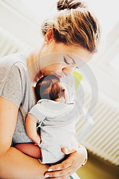 Happy young mother with newborn baby in hospital