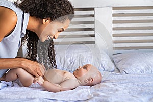 Mother changing baby diaper