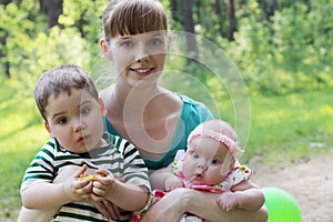 Happy young mother with two surprised kids