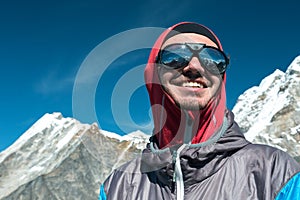 Happy young Mountain Climber in Sunglasses and protective Clothing