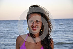 Happy young mulato woman at sea beach photo