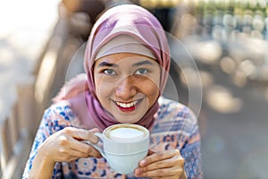 Happy Young Muslim Woman Drinking Coffee