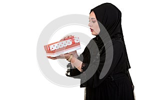 Happy young muslim woman with shopping bag and gift boxes isolated over white background