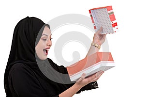 Happy young muslim woman with shopping bag and gift boxes isolated over white background