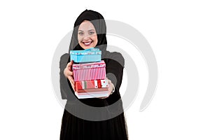 Happy young muslim woman with shopping bag and gift boxes isolated over white background