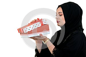 Happy young muslim woman with shopping bag and gift boxes isolated over white background