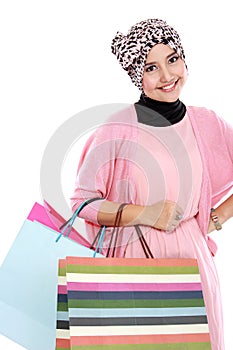 Happy young muslim woman with shopping bag