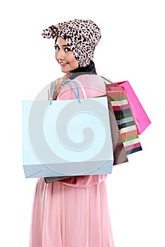 Happy young muslim woman with shopping bag