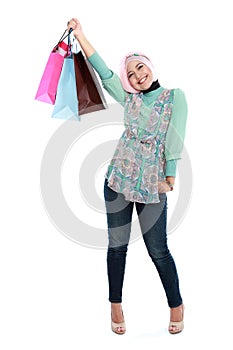 Happy young muslim woman with shopping bag