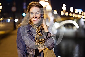 Happy young natural woman toothy smile on Margaret bridge at night, Budapest