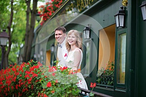 Happy young newly-wed couple on a balcony