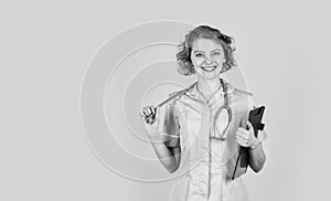 happy young nurse holding clipboard. female medical doctor use stethoscope. therapist in uniform at hospital. medical