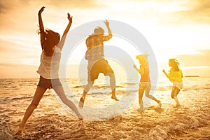 happy young people dancing on the beach