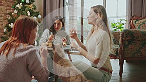 happy young people eating pizza at home, smiling face cheerful female group enjoying food meal dining sitting together