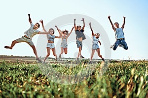 Happy young people jumping in mountains