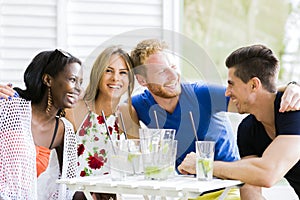 Happy young people laughing a being happy at a table