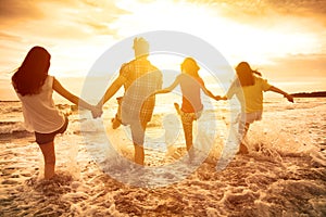 happy young people playing on the beach