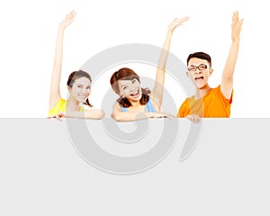 Happy young people raise hand to greet with empty board