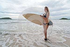 Happy young people with surfboard on the beach.