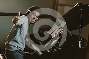 happy young piano player showing