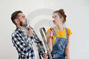 Happy young playful family having fun with each other during apartment redecoration