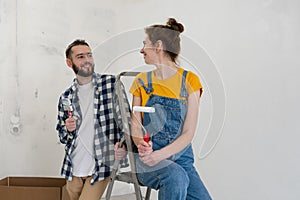 Happy young playful family having fun with each other during apartment redecoration