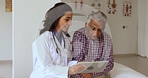 Happy young practitioner woman showing test result to Indian patient