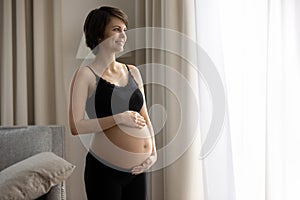 Happy young pregnant woman look in distance feeling excited