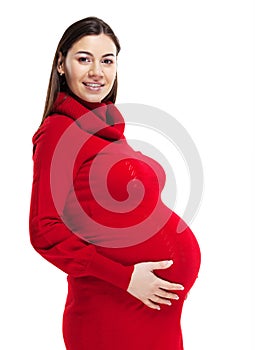 Happy young pregnant woman in red dress