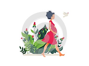 Happy young pregnant woman walking in the beautiful garden. Active well fitted pregnant female character.