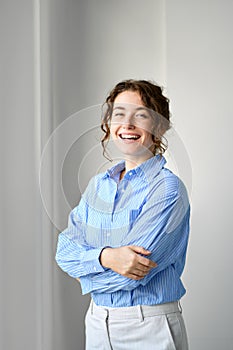 Happy young professional business woman laughing, vertical portrait.