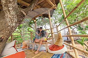 Happy Young Romantic caucasian Couple in gazebo on the tree, tropical Bali island, Indonesia.. Vacation Honeymoon