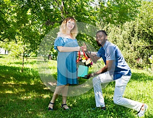 Happy young romantic couple in love. Black man and white woman. Love story and people`s attitudes. Beautiful marriage concept. photo