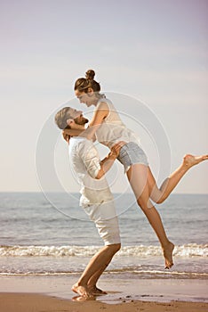 Happy young romantic couple in love have fun on beautiful beach at beautiful summer day.