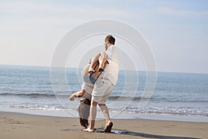 Happy young romantic couple in love have fun on beautiful beach at beautiful summer day.