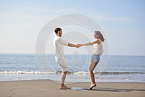 Happy young romantic couple in love have fun on beautiful beach at beautiful summer day.