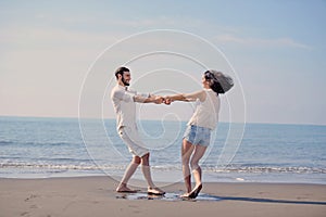 Happy young romantic couple in love have fun on beautiful beach at beautiful summer day.