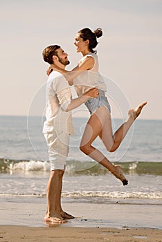 Happy young romantic couple in love have fun on beautiful beach at beautiful summer day.