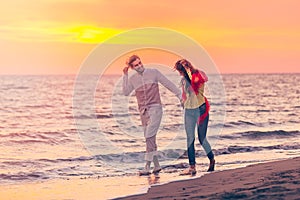 Happy young romantic couple in love have fun on beautiful beach at beautiful summer day