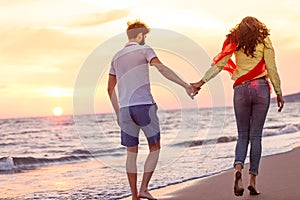 Happy young romantic couple in love have fun on beautiful beach at beautiful summer day