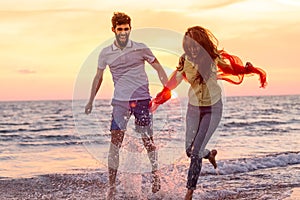 Happy young romantic couple in love have fun on beautiful beach at beautiful summer day