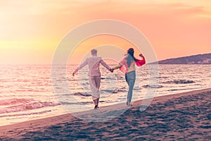 Happy young romantic couple in love have fun on beautiful beach at beautiful summer day