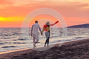 Happy young romantic couple in love have fun on beautiful beach at beautiful summer day