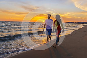 Happy young romantic couple in love have fun on beautiful beach at beautiful summer day