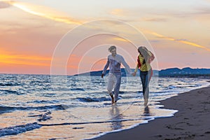 Happy young romantic couple in love have fun on beautiful beach at beautiful summer day