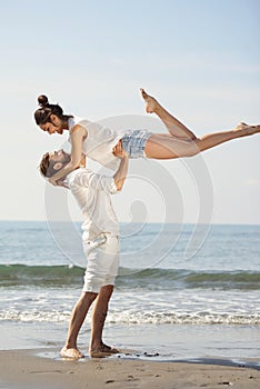 Happy young romantic couple in love have fun on beautiful beach at beautiful summer day.