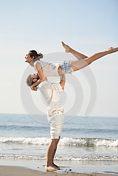 Happy young romantic couple in love have fun on beautiful beach at beautiful summer day.