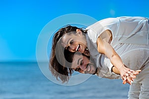 Happy young romantic couple in love have fun on beautiful beach