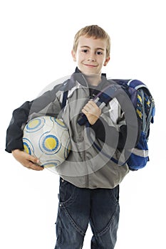 Happy young school boy holding a football ball