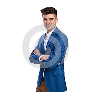 Happy young smartcasual man standing with hands crossed is laugh